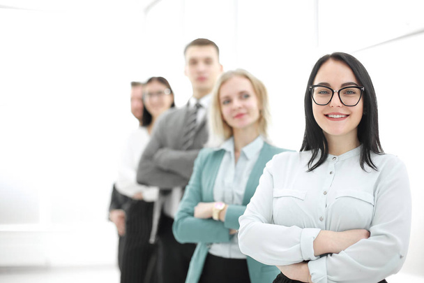 confident businesswoman standing in front of his business team - 写真・画像