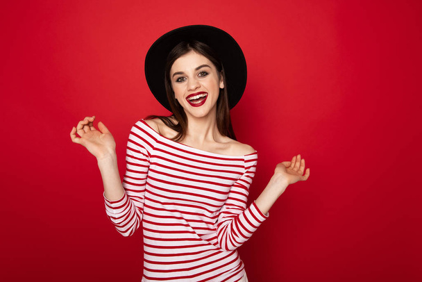 Pretty happy lady in striped blouse and black hat - Zdjęcie, obraz