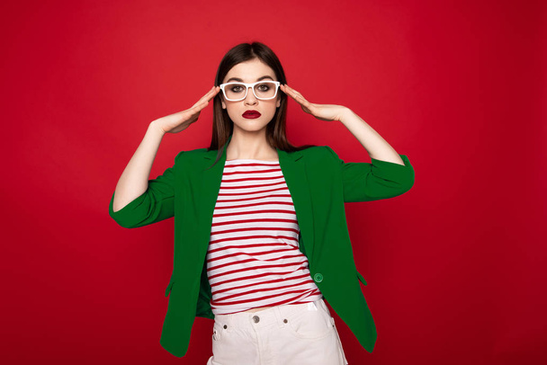Young stylish lady gracefully holding on glasses - Fotografie, Obrázek