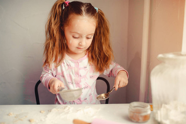 Cute little girl have fun in a kitchen - Fotó, kép