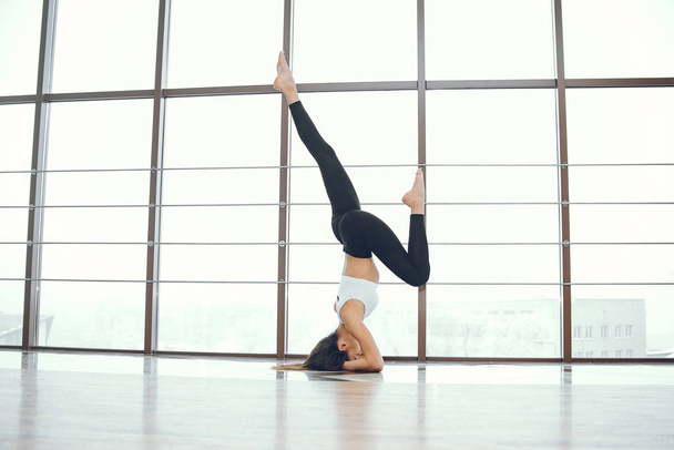 Beautiful and elegant girl doing yoga - Фото, изображение
