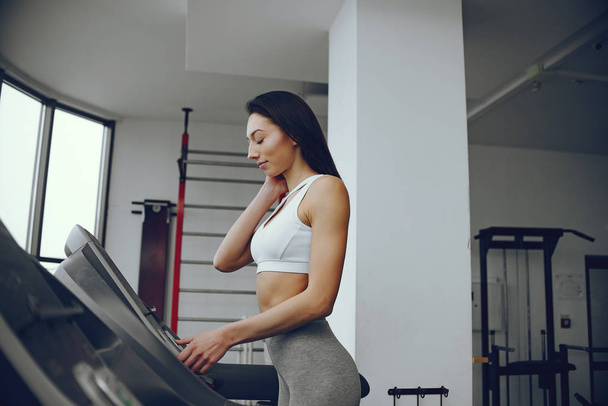 Beautiful and elegant girl standing in a gym - Photo, Image