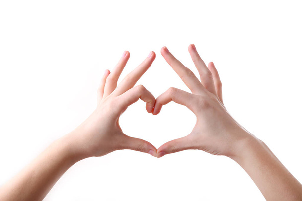 Female hands in heart shape on white background - Foto, afbeelding