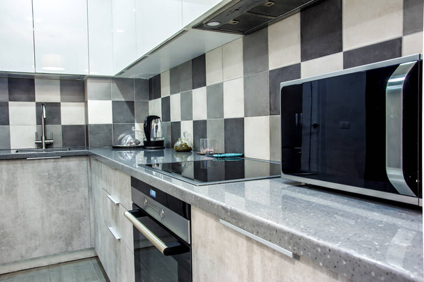 Modern home interior kitchen decor elements with gray cement set and segments of luxury furnishings empty apartment with appliances and fridge - Φωτογραφία, εικόνα