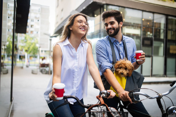 Beautiful romantic couple is having rest in the city with dog and bicycles - Fotografie, Obrázek