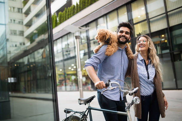 Beautiful romantic couple is having rest in the city with dog and bicycles - Fotó, kép