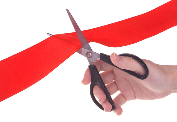 Hand with scissors cutting red ribbon - Photo, Image