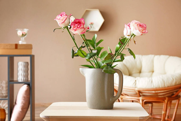 Vase with beautiful flowers on table in room - Foto, Bild