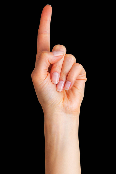 Woman hand with the index finger pointing up - Foto, Imagen