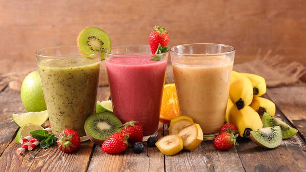 assorted fruit juice, smoothie on wood background - Foto, afbeelding