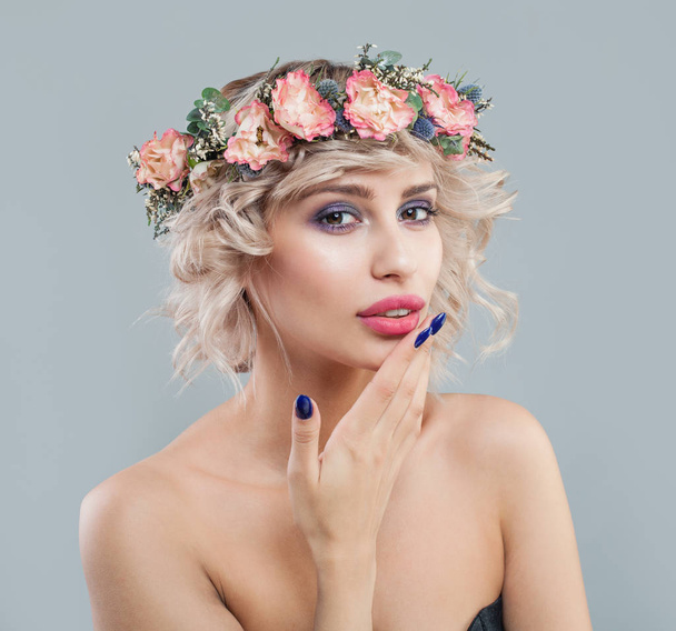 Mujer bonita con piel clara, maquillaje, flores y pelo corto y rizado
 - Foto, Imagen