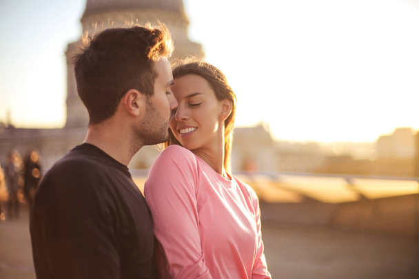 Lovely couple on a romantic date on a rooftop - Foto, imagen
