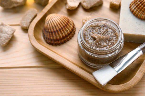 Jar with sugar scrub and ingredients on wooden table - Valokuva, kuva