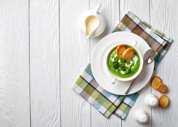 broccoli cream soup in a white bowl  - Fotó, kép
