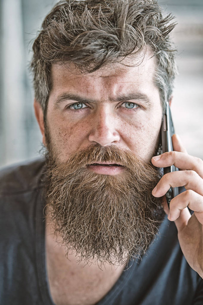 Hipster bearded communicate smartphone call. Mobile communication. Communication concept. Man with beard and mustache mobile phone conversation defocused background. Bearded man hold mobile phone - Foto, immagini