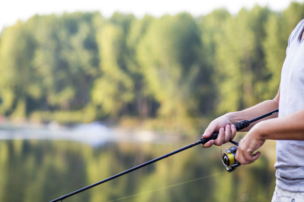 Fisherman. Young man fishing on the river. - Foto, imagen