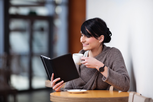 Young woman sitting in the restaurant with digital tablet - Φωτογραφία, εικόνα