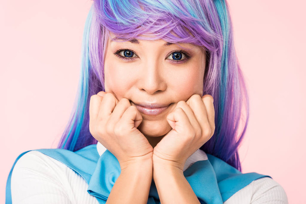 Smiling asian anime girl in wig posing isolated on pink - Valokuva, kuva