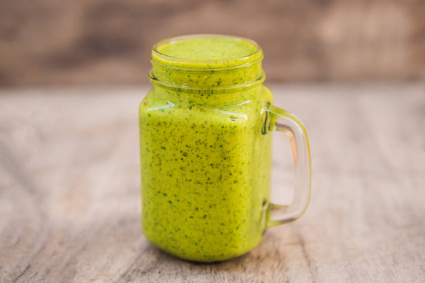 Ginger green apple smoothie on concrete background. It can be used as a background - 写真・画像
