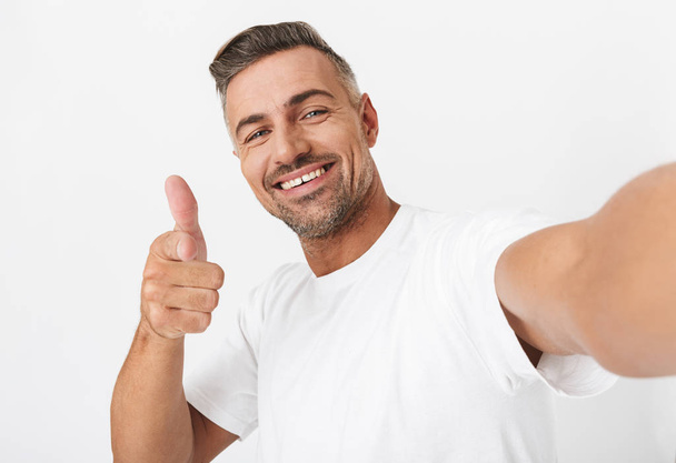 Image closeup of excited man 30s wearing casual t-shirt looking  - Фото, зображення
