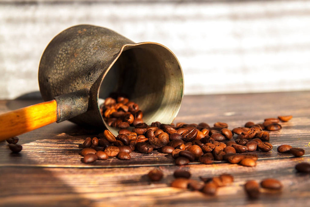 coffee beans and turk on a wooden background. - Φωτογραφία, εικόνα