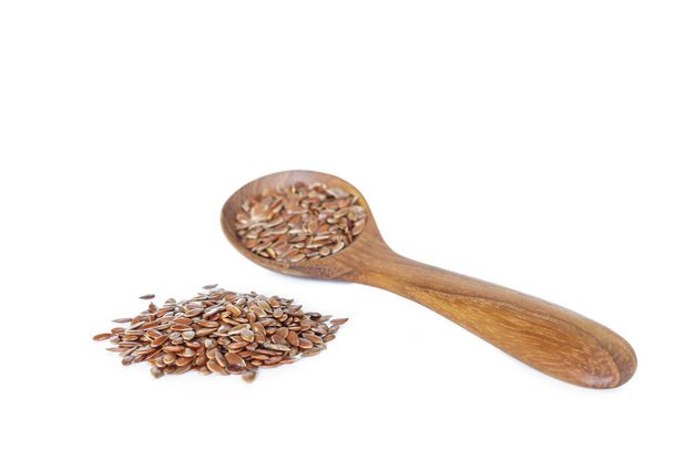 Brown flax seed in spoon on white background. - Photo, Image