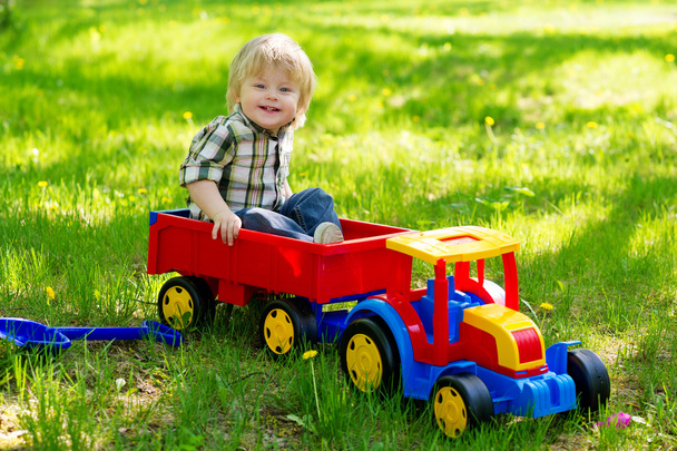 Little boy in his toy truck - Zdjęcie, obraz