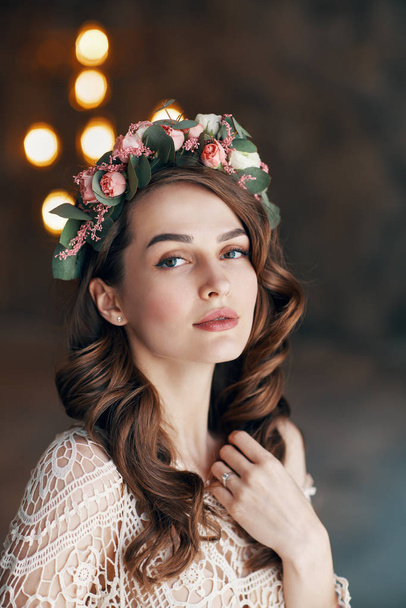 Beauty portrait of young woman with wreath of flowers in her hair. Fashion concept                                - Foto, immagini