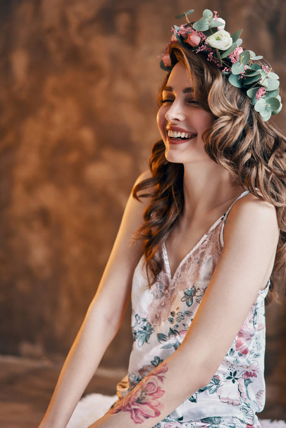 Happy beautiful woman portrait with wreath of flowers in her hair. Careless concept                               - Zdjęcie, obraz