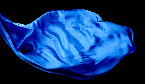 Smooth elegant blue transparent cloth isolated on black backgrou - Photo, image