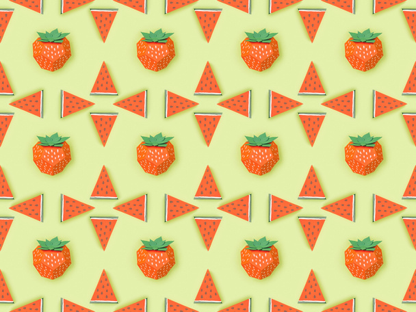 top view of pattern with handmade red paper strawberries and watermelon slices isolated on green - Photo, Image