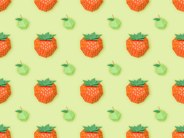 top view of seamless pattern with handmade paper strawberries and apples isolated on green - Photo, Image