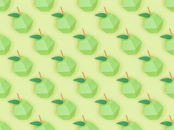 top view of pattern with handmade paper apples isolated on green - Foto, Imagem