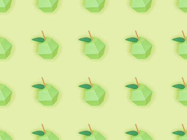 top view of pattern with handmade paper apples isolated on green - Foto, Imagem