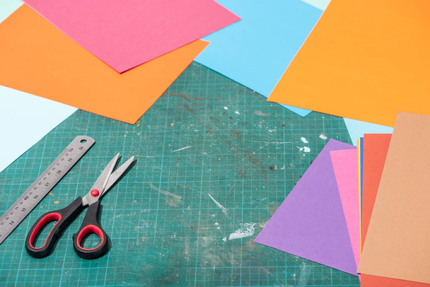 colorful cardboard with scissors and ruler on messy surface - Foto, Imagen
