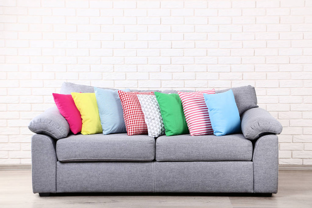 Colorful soft pillows on grey sofa - Foto, afbeelding