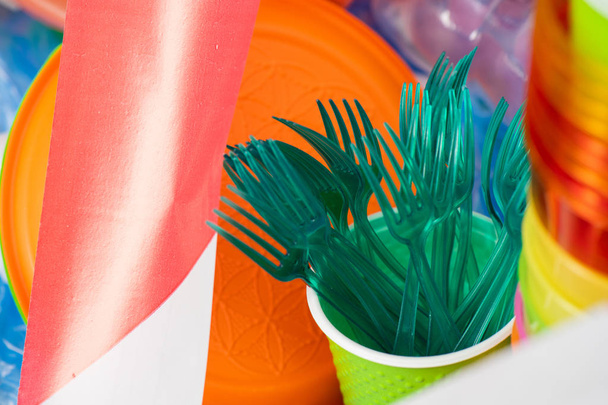 Toxic green plastic forks collected in a cup - Foto, Imagem