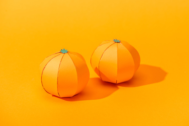handmade tangerines made of paper on orange with shadow - Photo, Image