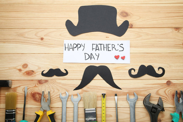 Inscription Fathers Day with different tools on brown wooden tab - Fotografie, Obrázek