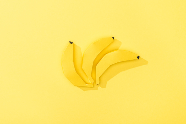 top view of handmade paper bananas on yellow - Zdjęcie, obraz