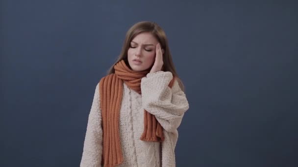 Sick girl wrapped in a warm scarf suffering from nose and headache - Кадры, видео