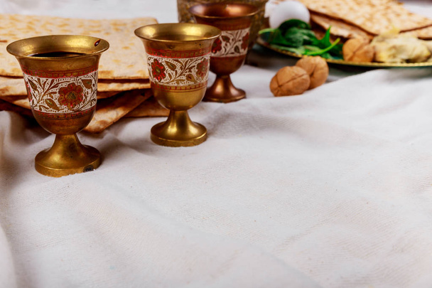 Passover matzoh jewish holiday bread, four glasses kosher wine over table. - Photo, Image