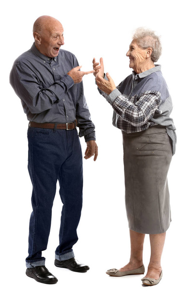 Talking senior couple on white background - Фото, зображення