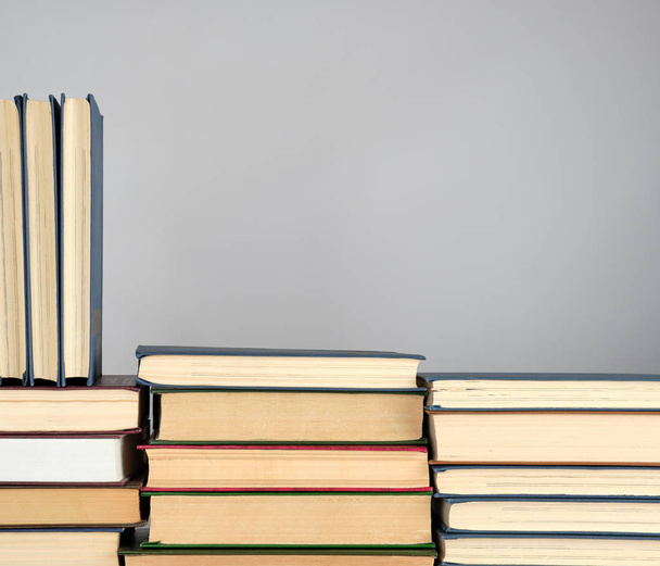 stack of different books on a gray background - Photo, Image