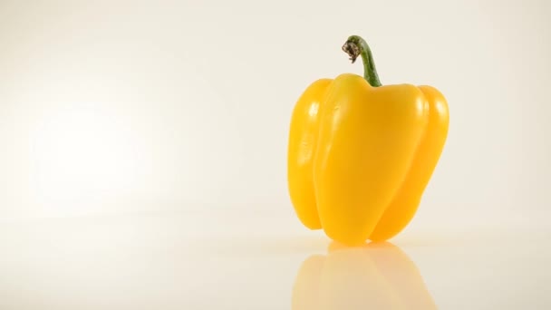 Rotating Yellow Pepper On Acrylic Against White - Dolly Right - Footage, Video