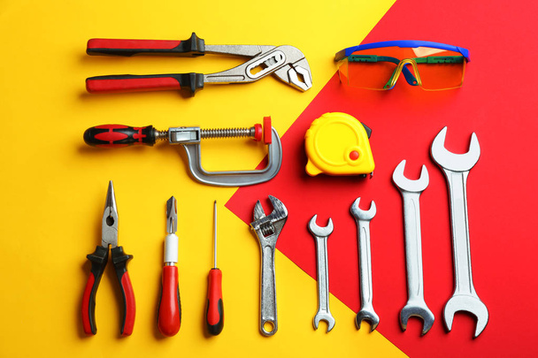 Flat lay composition with construction tools on color background - Photo, image