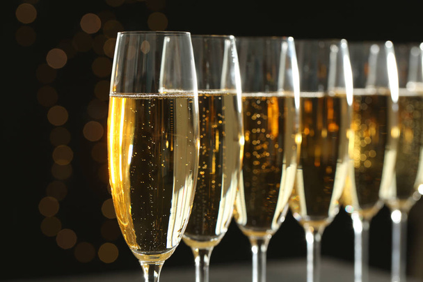 Many glasses of champagne on blurred background, closeup - Фото, изображение