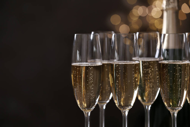 Glasses of champagne on blurred background, closeup. Space for text - Фото, изображение