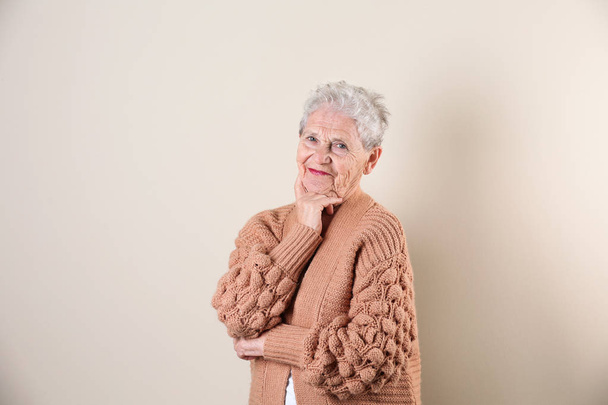 Portrait of grandmother in stylish clothes on light background - Foto, Imagem