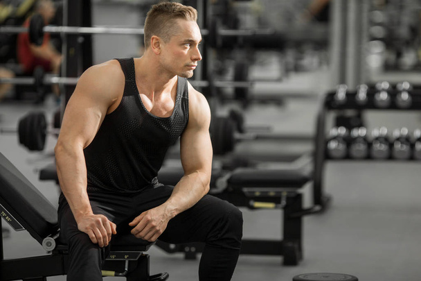 handsome man in good shape with muscles in the gym - 写真・画像